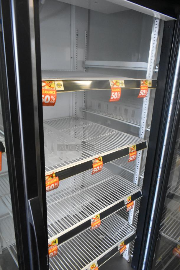2016 True GDM-72-HC 3 Door Cooler Merchandiser with poly-coated racks, 115 volts, 1 phase. Clearance tags visible.