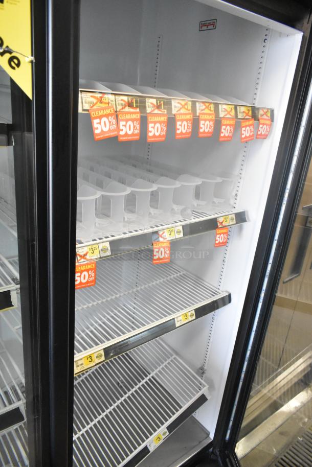 2016 True GDM-72-HC commercial cooler, three glass doors, poly-coated racks, labels show 50% clearance.