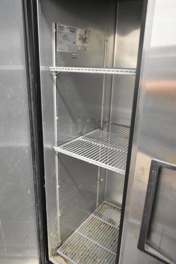 True T-35 stainless steel commercial cooler with two doors and poly-coated racks, 115V, 1 phase. Interior label details model info.
