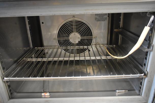 Standex BCF44244-0AX6 stainless steel undercounter blast chiller interior, fan and wire shelves visible, 220V, single-phase.