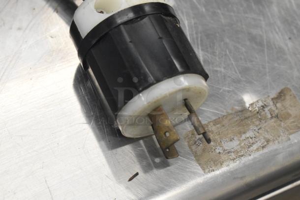 Close-up of a power plug for the Standex BCF44244-0AX6 blast chiller, showing a used condition on a stainless steel surface.