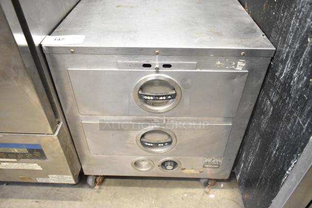 Toastmaster Stainless Steel 2 Drawer Warming Drawer, commercial-grade, with visible wear. Model name visible on drawer handles.