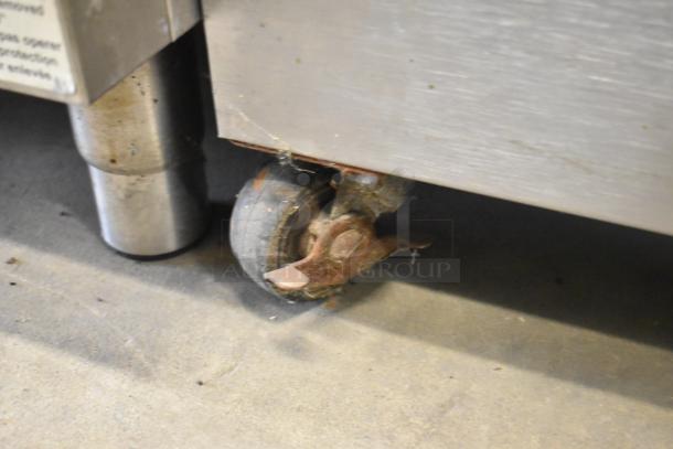 Toastmaster stainless steel commercial warming drawer with two drawers. Visible caster wheel and leg indicate mobility and sturdiness.