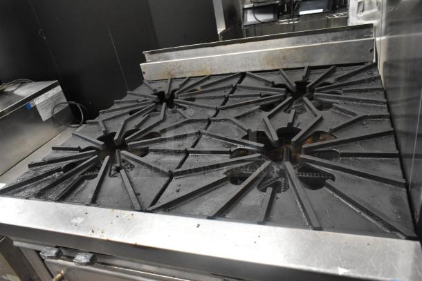 Montague stainless steel commercial gas-powered 4 burner range with oven, features sturdy commercial casters.