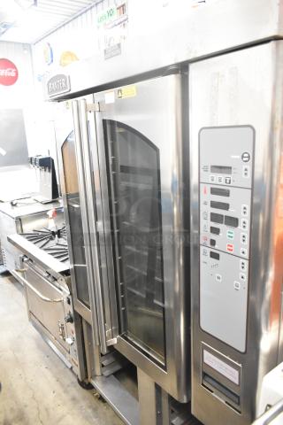 Baxter OV310G stainless steel commercial mini rotating rack oven, on double pan rack with casters, control panel visible.