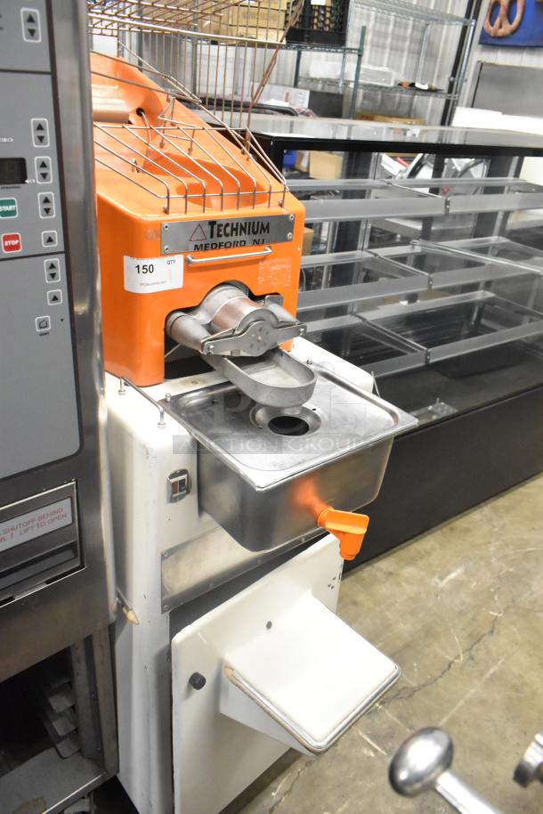 Metal commercial citrus juicer on casters, Technuim brand, 115 volts, 1 phase, in good condition.