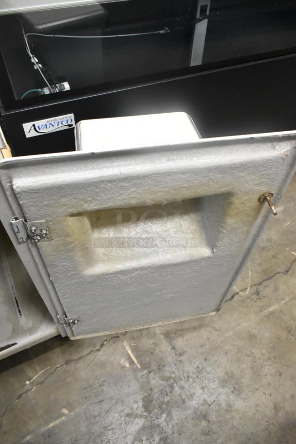 Metal commercial floor-style citrus juicer on casters, 115 volts, 1 phase, used condition.