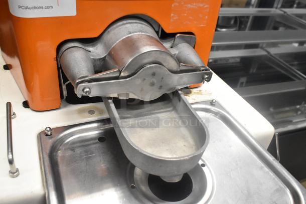 Metal commercial floor citrus juicer on casters, 115 volts, 1 phase; features stainless steel components, good condition.