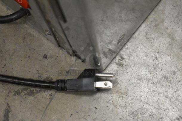 Avantco model 193BCFD72B power cord and metal frame detail; 120V black bakery display case, new with minor scratches.