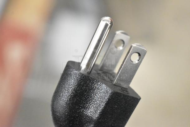 Close-up of a three-prong electrical plug, part of the Avantco 177SL312 meat slicer. 115 volts, for use with 1/3 hp motor.