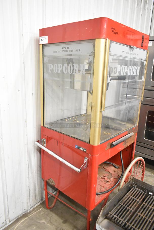 Carnival King G14-A metal popcorn machine, 120V, red, fair condition, visible wear, clear glass with "Popcorn" label.