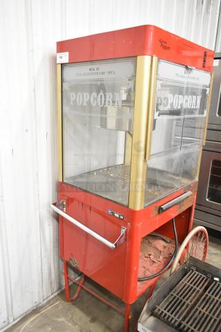Carnival King G14-A metal popcorn machine, 120V, red, fair condition, visible wear, clear glass with "Popcorn" label.