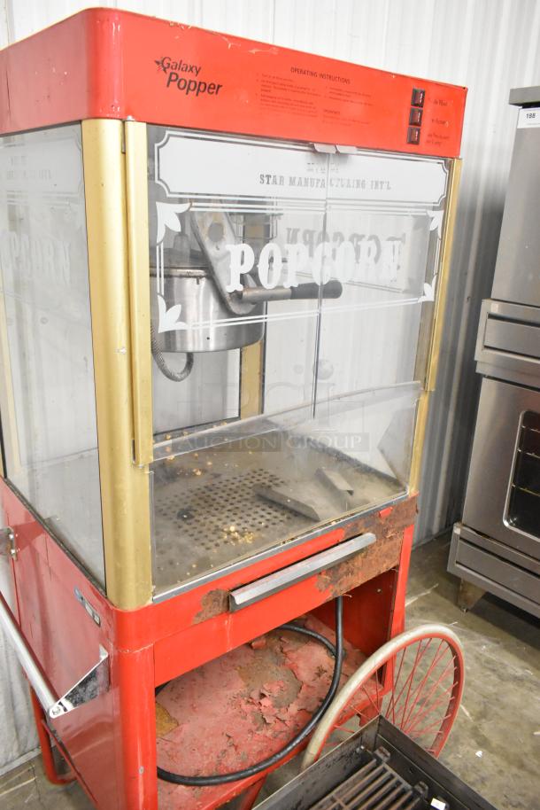 Carnival King G14-A metal popcorn machine, commercial use, 120 volts, visible wear and rust, classic red design.