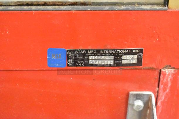 Carnival King G14-A commercial popcorn machine in red. Features a tag with model G14-A, 120 volts, and 2416 watts.