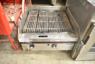 APW Wyott stainless steel commercial countertop gas charbroiler grill with dual knobs, visible signs of use, and label details.