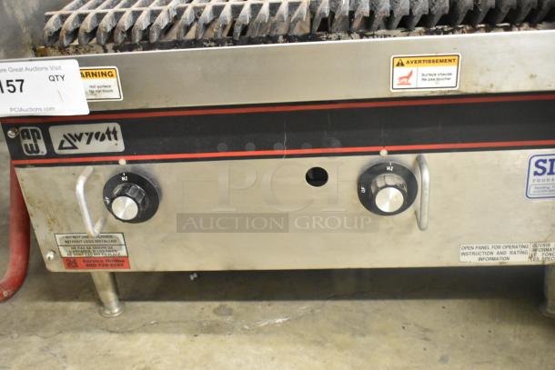 APW Wyott stainless steel gas charbroiler grill. Features control knobs, warning labels, and sturdy legs. Used condition.