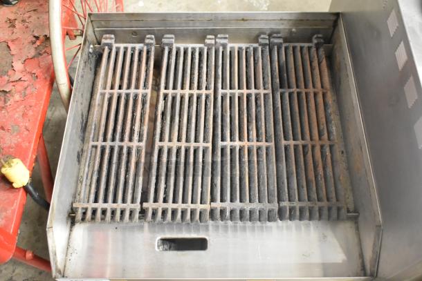 APW Wyott stainless steel commercial countertop gas charbroiler grill with visible wear, featuring cast iron grates.