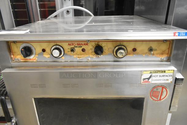 Alto Shaam stainless steel Cook N Hold oven, visible control knobs, "Caution Hot Surfaces" label, used condition.