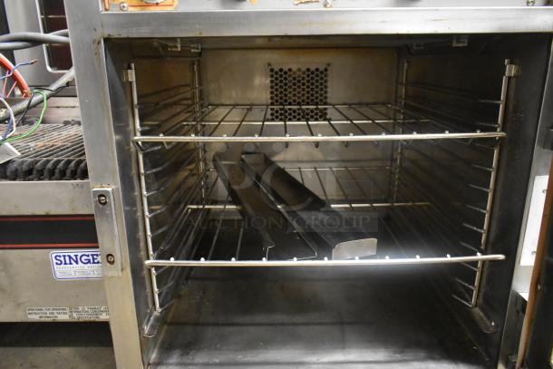 Alto Shaam stainless steel commercial Cook N Hold oven, open door showing interior racks, used condition.