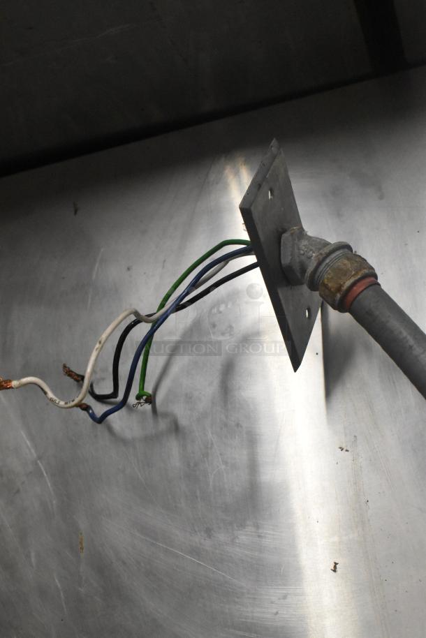 Close-up of wiring in Alto Shaam stainless steel commercial Cook N Hold oven, showing connection details.