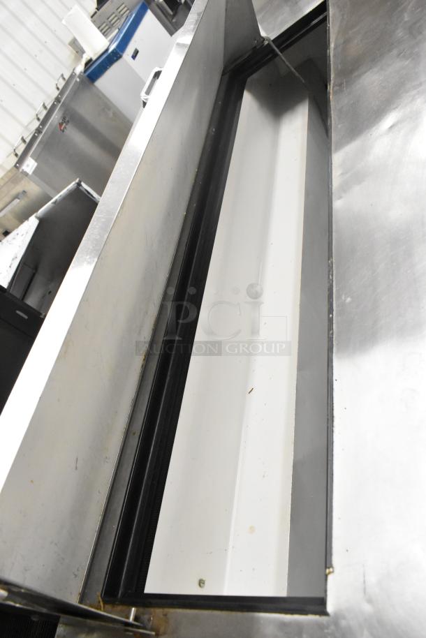 True TSSU-72-16 stainless steel prep table with bain marie mega top, 115V, 1 phase, shown on casters.