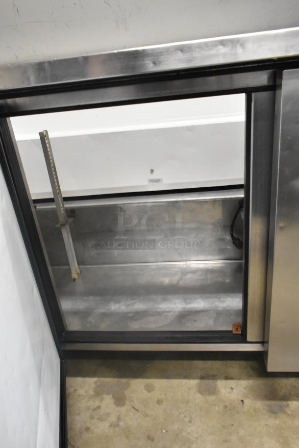 True TSSU-72-16 stainless steel sandwich prep table, bain marie top, commercial casters, 115V, 1 Phase, interior view.