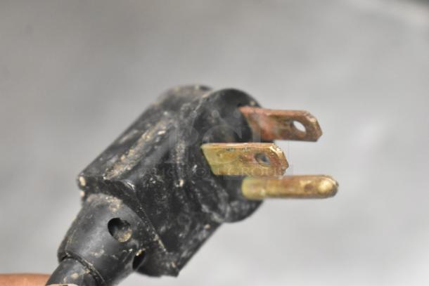 Close-up view of a three-prong plug from a True TSSU-72-16 commercial sandwich prep table, showing wear.