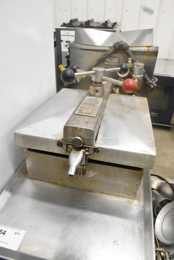 Henny Penny 600 stainless steel pressure fryer on commercial casters, 80,000 BTU. Visible wear, includes labels and controls.