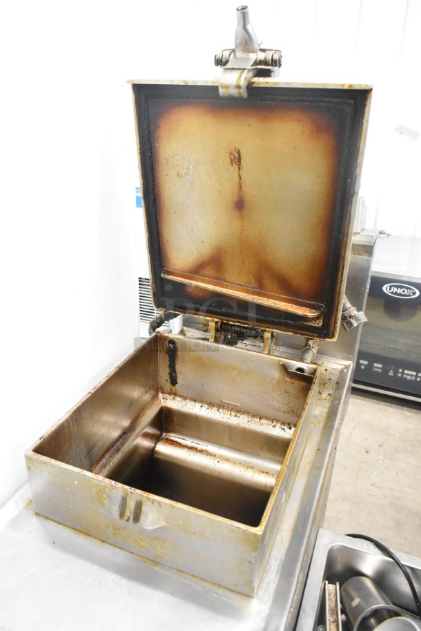 Henny Penny 600 stainless steel commercial pressure fryer, floor style, 80,000 BTU, on casters, signs of use visible.
