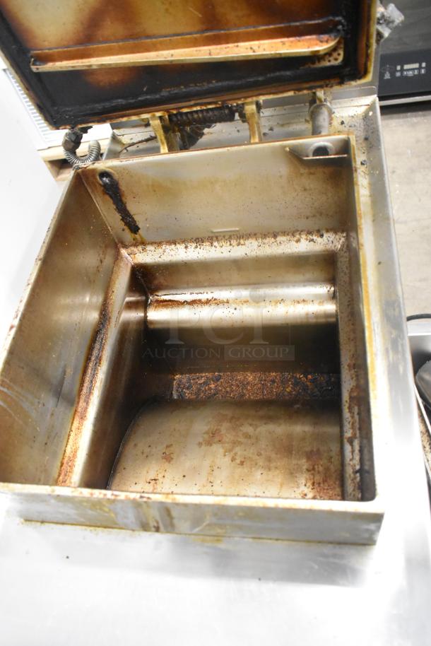Henny Penny 600 stainless steel pressure fryer, commercial floor style on casters, 80,000 BTU, visible signs of use.