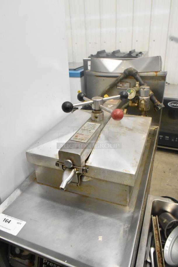 Henny Penny 600 stainless steel pressure fryer, 80,000 BTU, on commercial casters, visible control knobs, used condition.