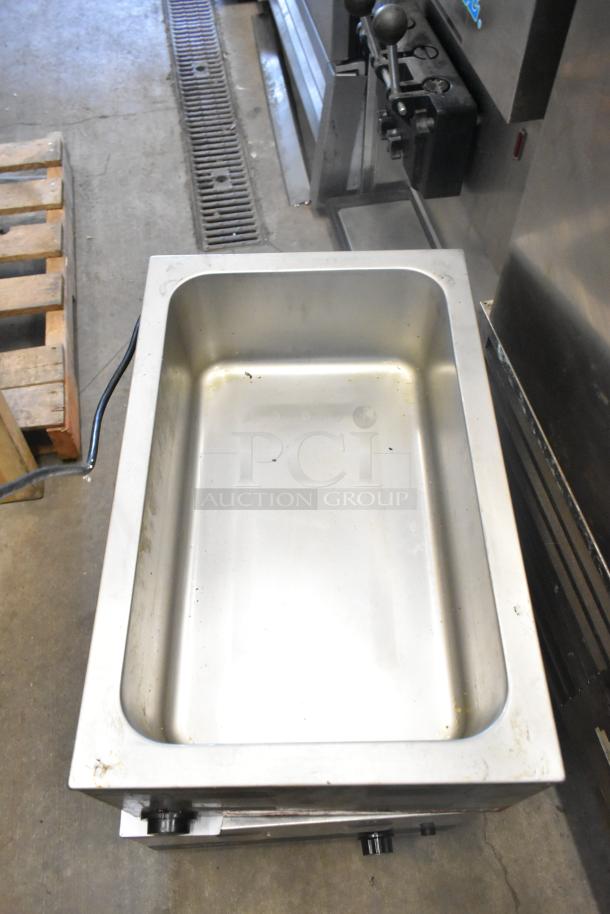 Two stainless steel food warmers, including Winco FW-S600 and Avantco models, 115 volts, 1 phase, used condition.
