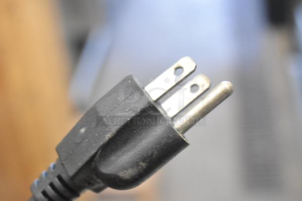 Close-up of a power plug for stainless steel food warmers, showing standard 115-volt compatibility.