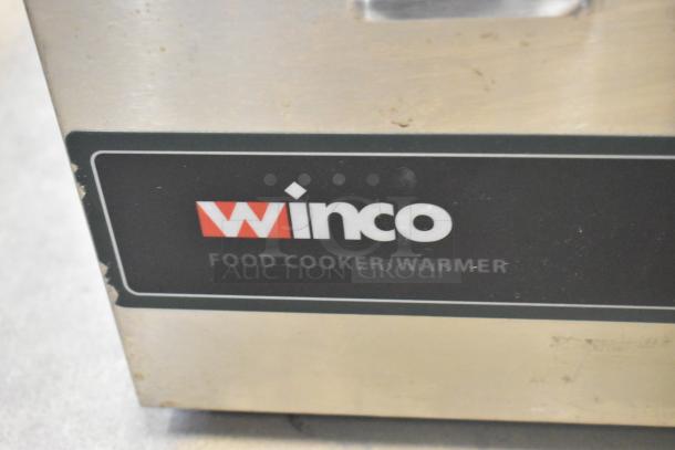 2 stainless steel food warmers, Winco FW-S600 and Avantco, 115 volts, 1 phase, some wear visible.