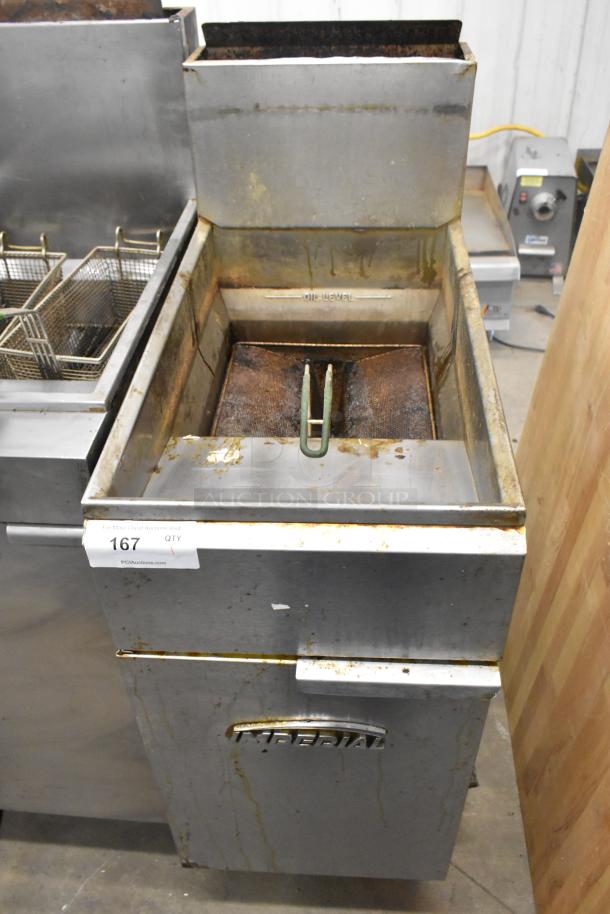 Imperial stainless steel gas deep fat fryer, commercial floor style, visible wear and oil residue, includes oil level markings.