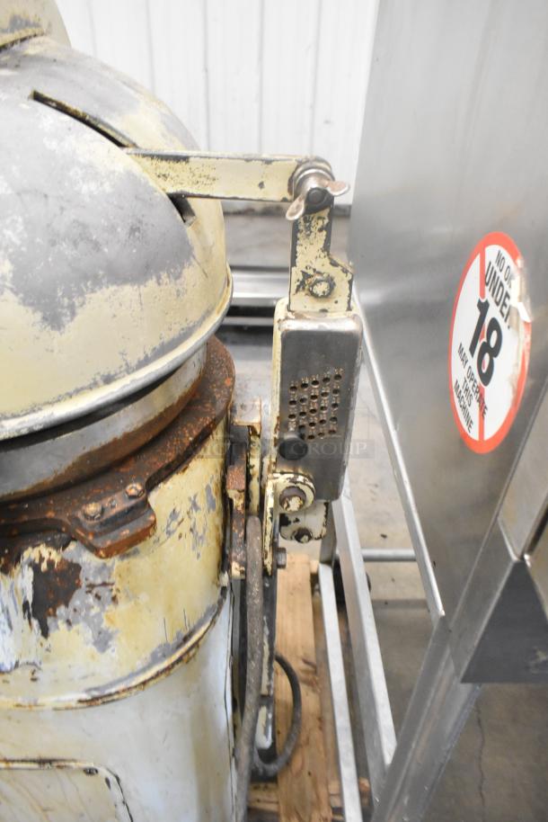 Fortuna Metal Commercial Floor Style Dough Divider, showing signs of wear and rust, features manual lever and safety label.