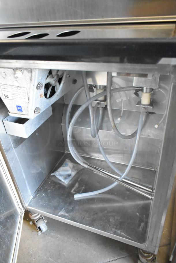 Stainless steel Electro Freeze 30TNCAB-213 soft serve ice cream machine interior, showing components and hoses on casters.