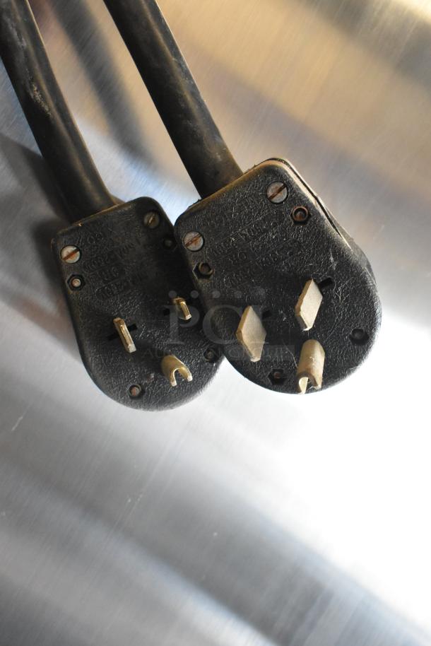 Two black power plugs for Electro Freeze 30TNCAB-213 soft serve machine, on stainless steel surface.