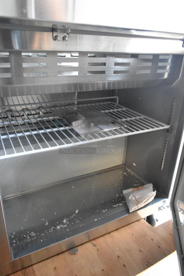 Brand new 2024 Avantco 178APT60MHC stainless steel sandwich salad prep table, interior view, minor scratches.