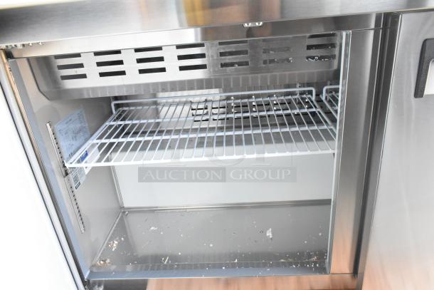Brand new Avantco 178APT60MHC stainless steel prep table with shelf shown. Includes interior label with specifications.
