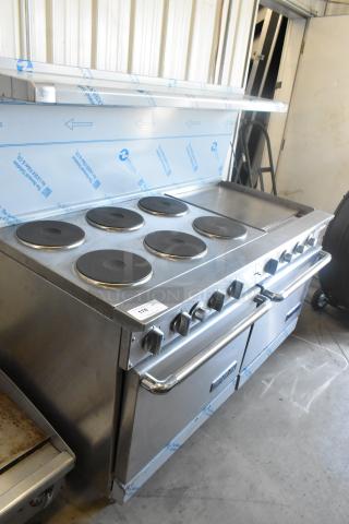 Imperial stainless steel electric 6-burner range with right-side griddle, 2 ovens, overshelf, and backsplash; excellent condition.