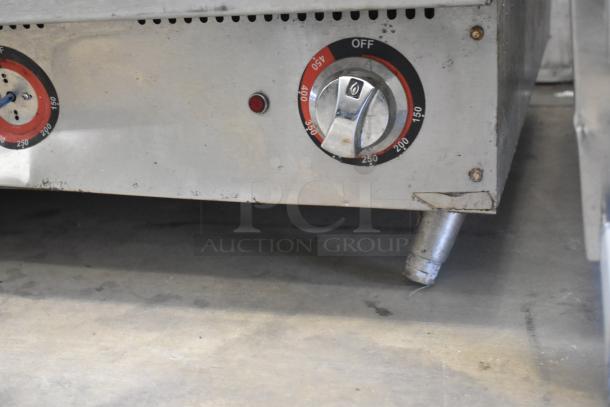 Star stainless steel griddle with thermostatic controls, showing temperature dial and sturdy legs, in used condition.