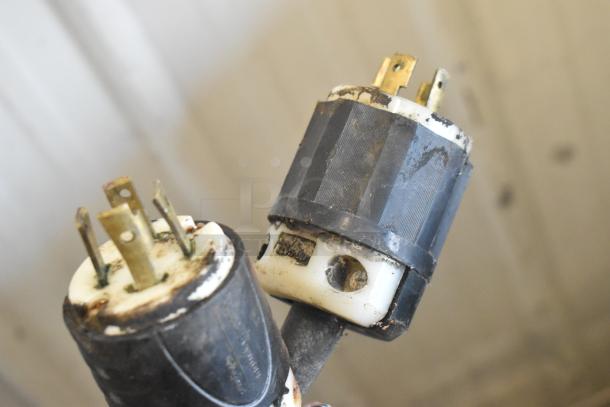 Star griddle power plug close-up, showing wear. Essential part indicates item's electrical condition.