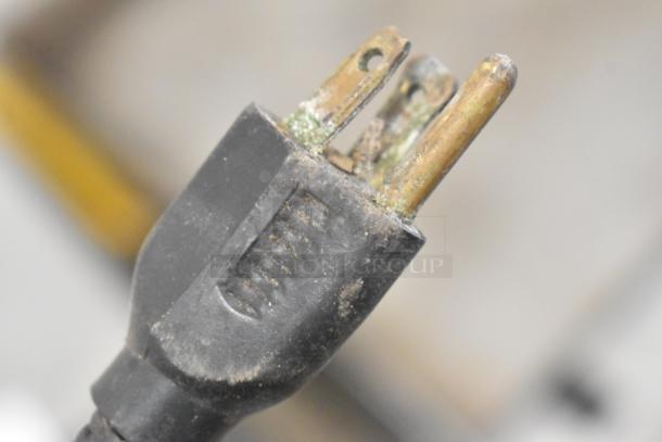 Close-up of a worn plug from Univex PM91 Meat Grinder. Visible corrosion on prongs, indicating used condition.