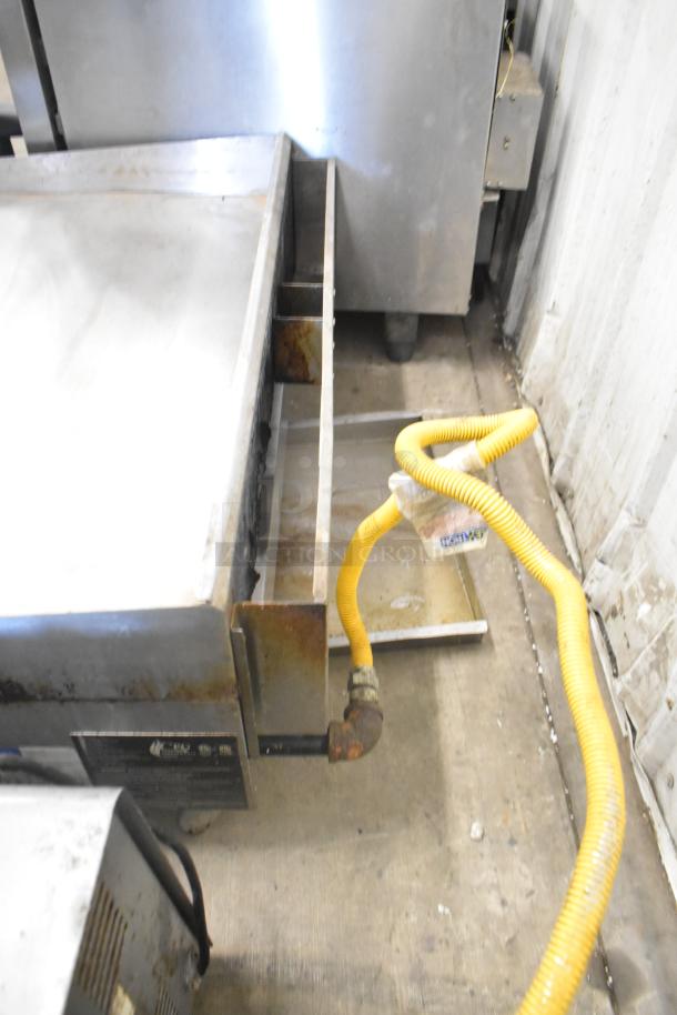 2023 CPG 351GMCPG36NL stainless steel griddle, natural gas, 90,000 BTU, visible wear, yellow gas hose attached.