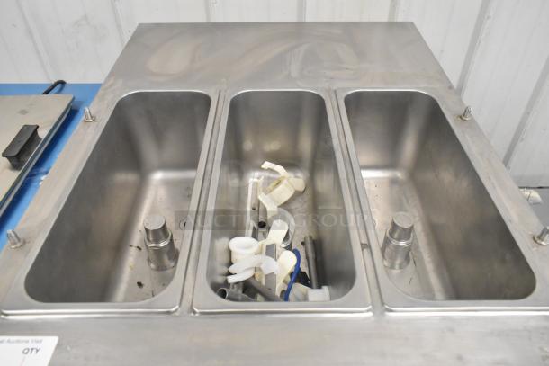 Stainless steel interior compartments of Spaceman Forte 6265W soft serve ice cream machine, parts visible inside.