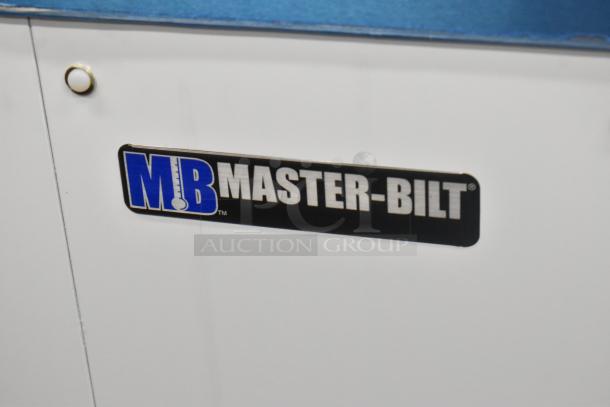 "Brand new 2022 Master-Bilt DC-4D commercial chest freezer, 115 volts, 1 phase, metal construction, logo visible."