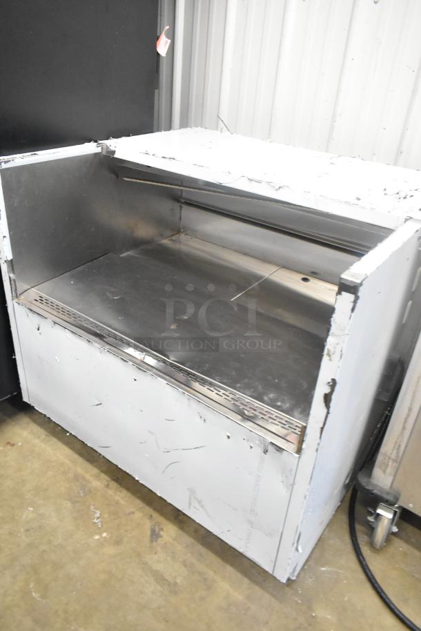 Stainless steel commercial horizontal open grab-and-go merchandiser, features a spacious display, visible wear on exterior.