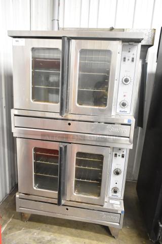 Two Garland SunFire stainless steel commercial full-size convection ovens with view doors, metal racks, and thermostat controls.