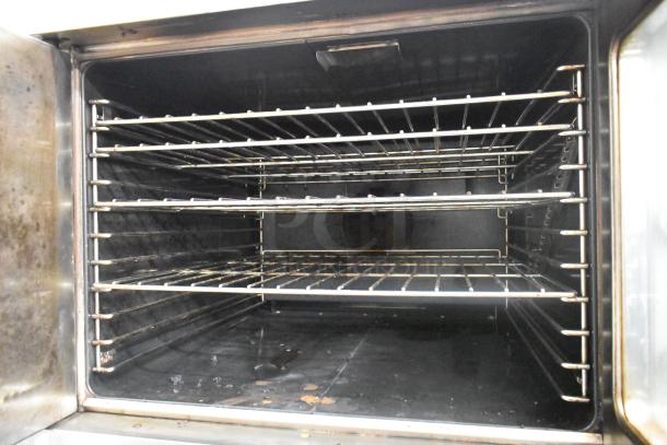 Garland SunFire convection oven with stainless steel finish, view-through doors, metal racks, thermostatic controls.